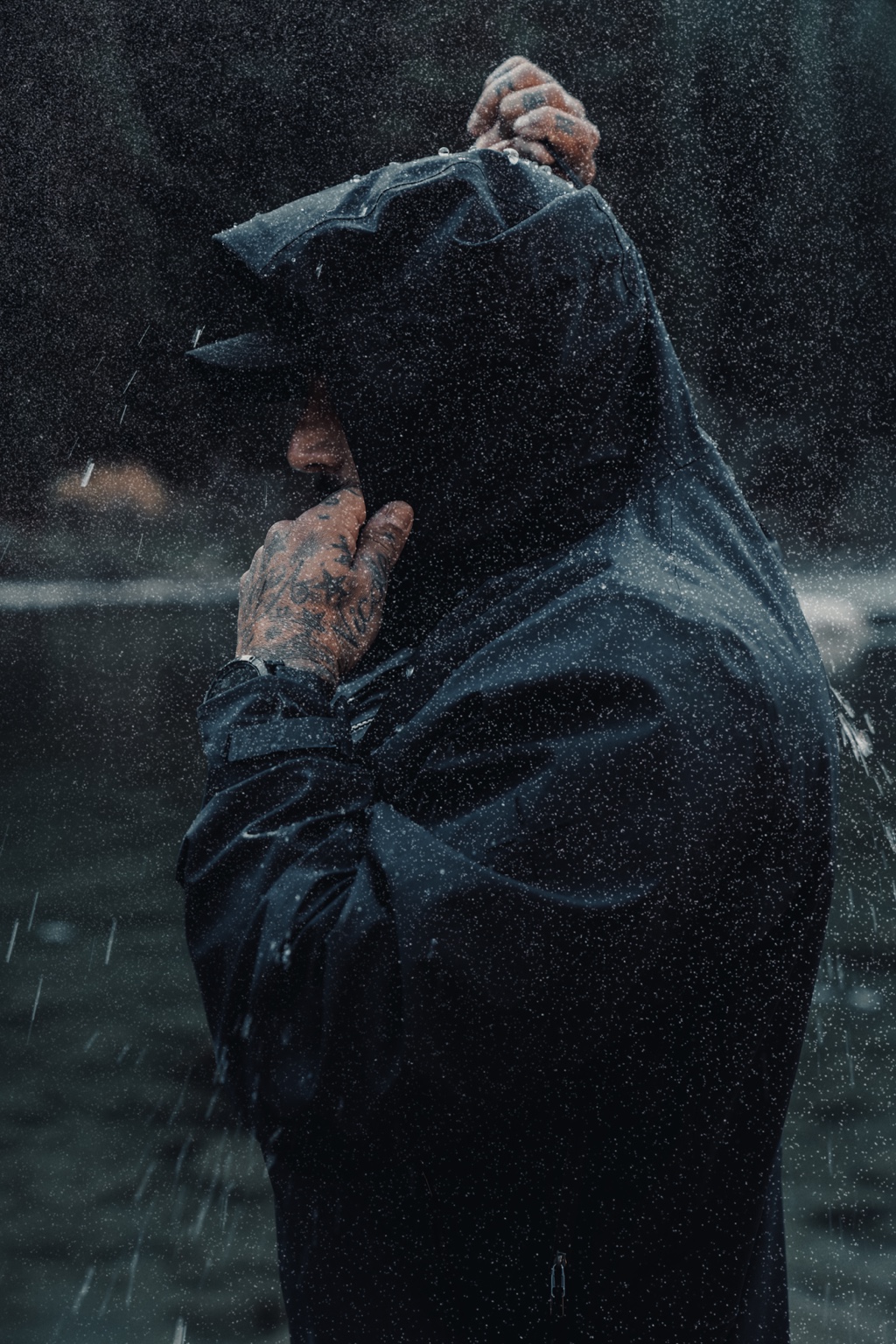 Rain-soaked editorial portrait in a technical jacket