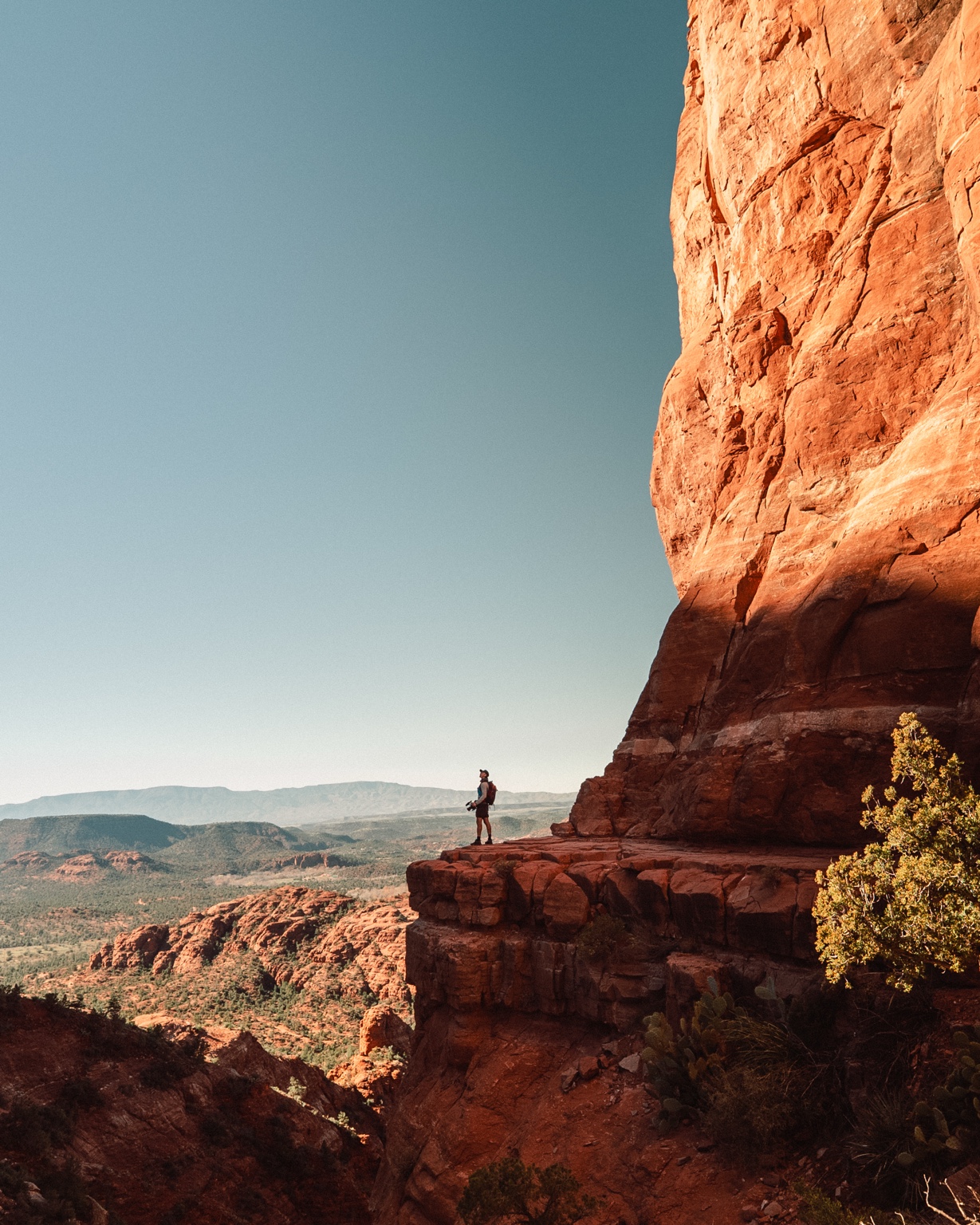 Lone figure against a red cliff